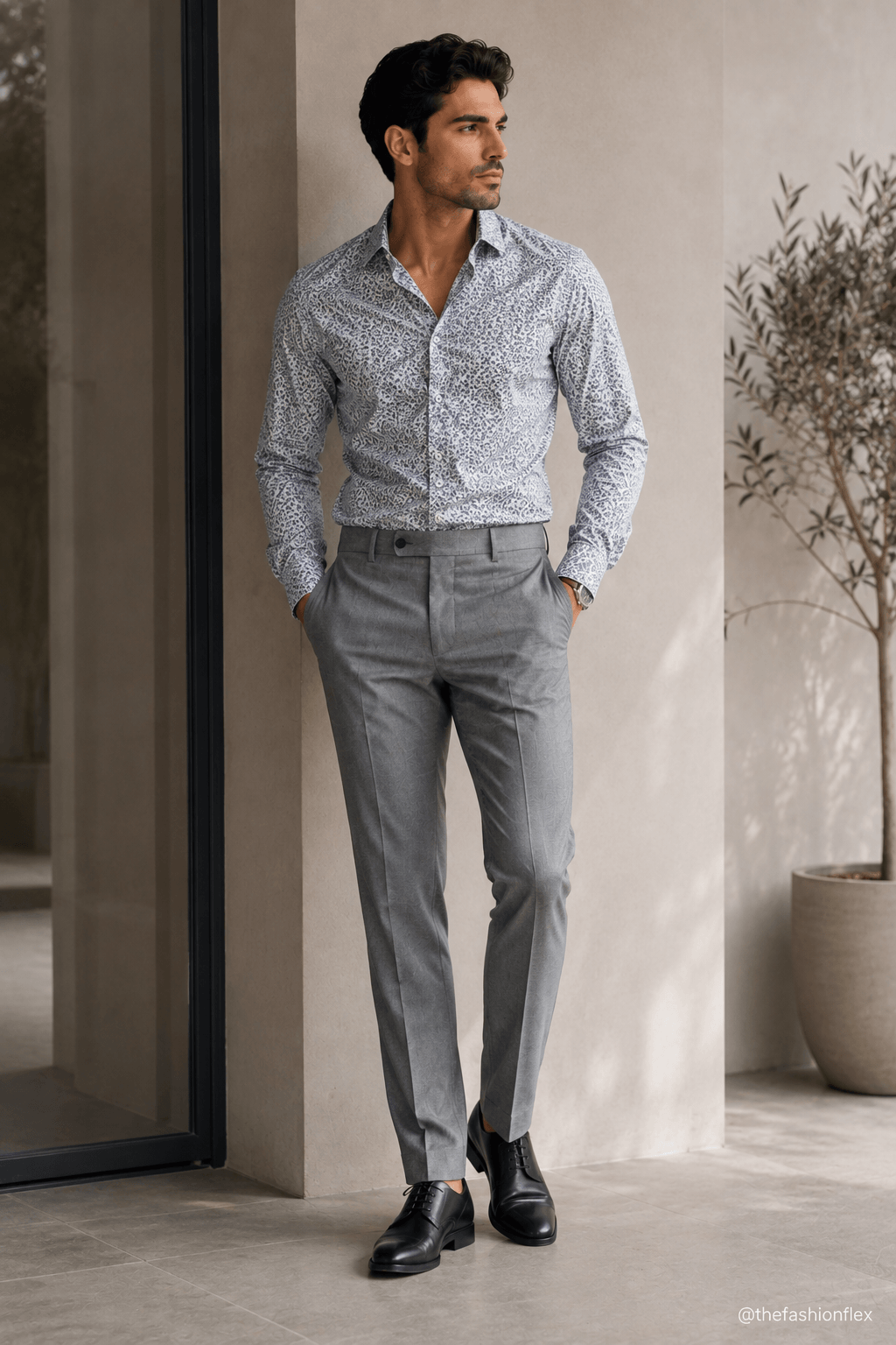 Man wearing a subtly printed shirt with grey trousers